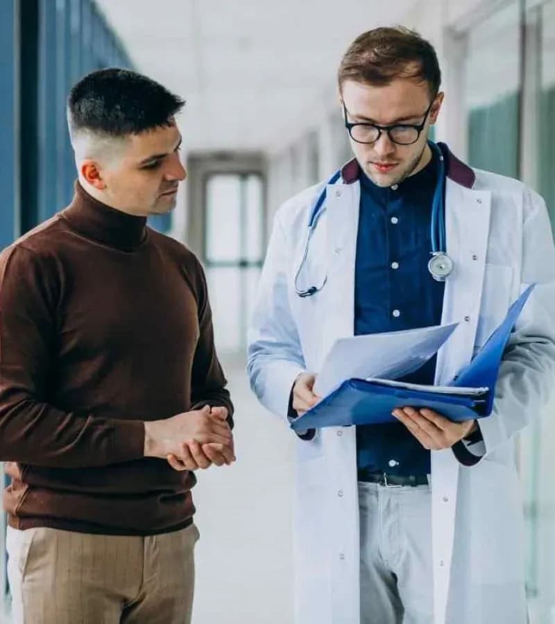 Pharmacist consulting a customer using Pharmacy Management Software for prescription management, billing, and pharmacy operations.